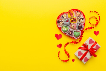 Valentine day composition: sweet candy, with gift boxes with bow and red felt hearts, photo template, background. Top View with copy space