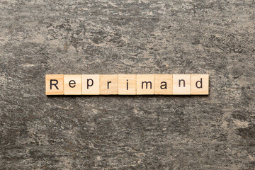 reprimand word written on wood block. reprimand text on table, concept