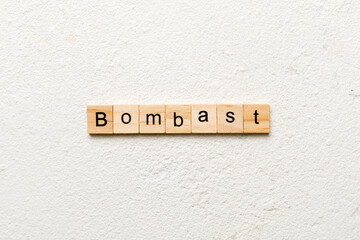 bombast word written on wood block. bombast text on cement table for your desing, concept