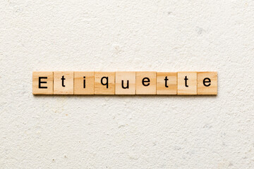 ETIQUETTE word written on wood block. ETIQUETTE text on cement table for your desing, concept