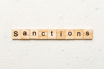 sanction word written on wood block. sanction text on table, concept