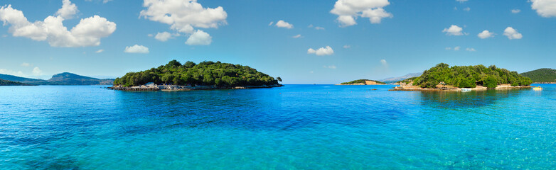 Fototapeta premium Beautiful Ionian Sea with clear turquoise water and morning summer coast. View from Ksamil beach, Albania.