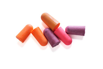 Earplugs with orange, pink and purple colors isolated on a white background, Soft silicone earplugs are a safety device used to reduce noise while sleeping.