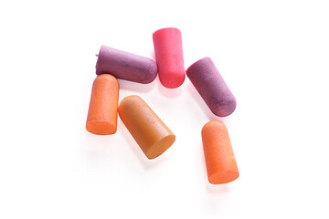 Earplugs with orange, pink and purple colors isolated on a white background, Soft silicone earplugs are a safety device used to reduce noise while sleeping.