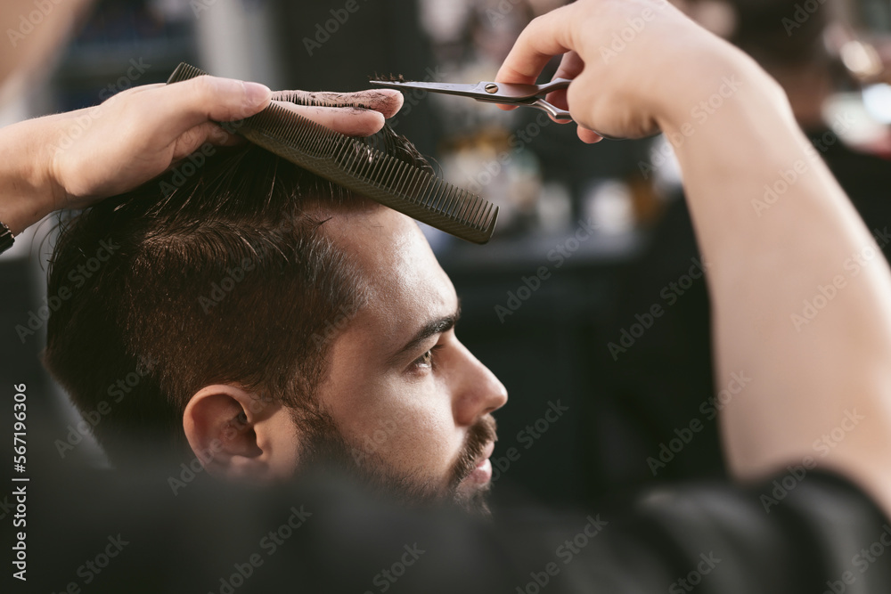 Canvas Prints Professional hairdresser working with bearded client in barbershop