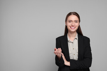 Portrait of beautiful young teacher on grey background. Space for text