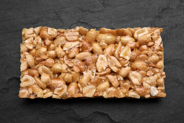 Delicious peanut bar (kozinaki) on black table, top view
