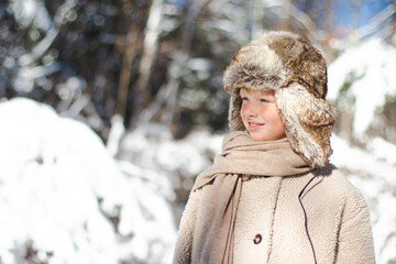 Smiling boy in winter forest