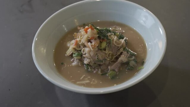 Close up to boiled and fried Pork Thai Menu with Shrimp Paste in white bowl that ready to serve and eat.