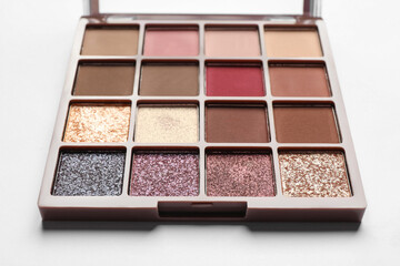 Beautiful eye shadow palette on white table, closeup