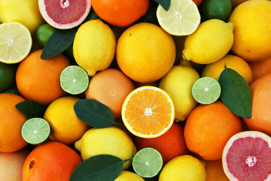 Many different whole and cut citrus fruits as background, top view © New Africa
