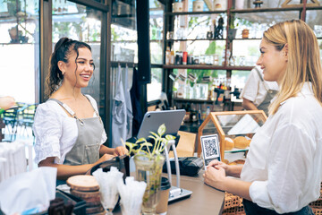 Caucasian attractive women receive coffee from waiter in coffee house. 
