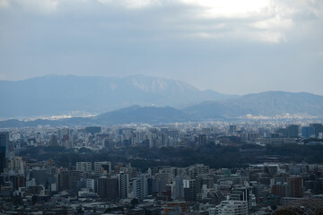 a cityscape where the snow stops and the sun shines slightly through the clouds
