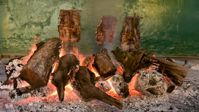 Shot of an Argentine Asado a la Estaca, roasting on a stake is a technique that uses wood fat to cook the meat

