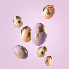 Beautiful flying Easter eggs on lilac background