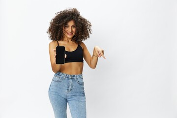 Woman blogger with phone in hand on white background selfies, video call, freelancer influencer job in social media and media, technology for work, smile curly hair copy spot