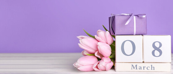 Calendar, gift and beautiful flowers on lilac background with space for text. Women's Day celebration