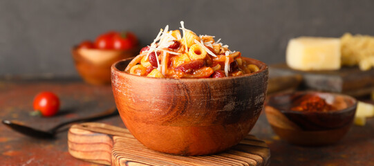 Bowl with tasty pasta and beans on table, closeup