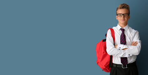 Teenage boy with backpack on grey background with space for text