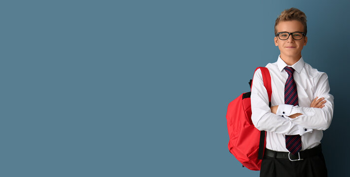Teenage boy with backpack on grey background with space for text