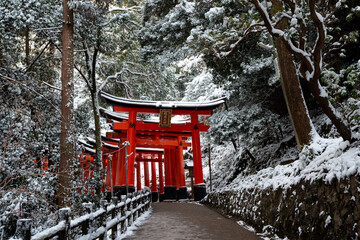 Kyoto, Japan. Fushimi Inari-taisha Torii Gates with snow on the roof in winter.
