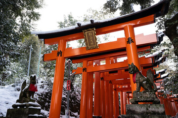 Kyoto, Japan. Fushimi Inari-taisha Torii Gates with snow on the roof in winter.