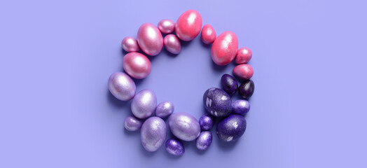 Frame made of beautiful Easter eggs on lilac background