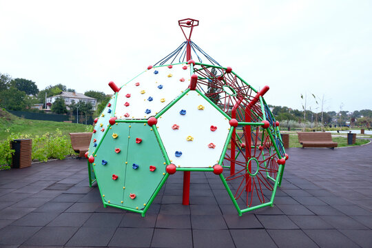 View of children's playground with climbing dome - Powered by Adobe