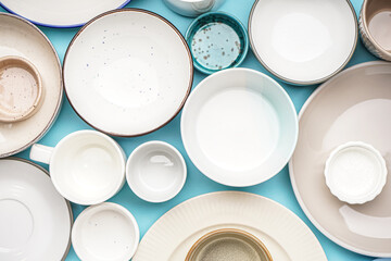 Different clean dishware on blue background