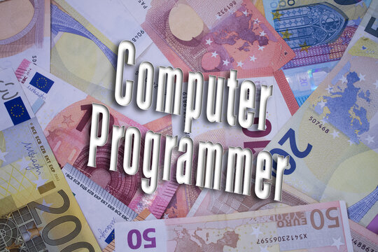 Computer Programmer word with money. Paper currency background with different banknotes.