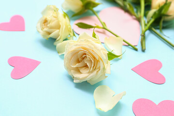 Composition with beautiful rose flowers and paper decor on color background, closeup