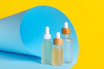 Bottles of natural serum on color background