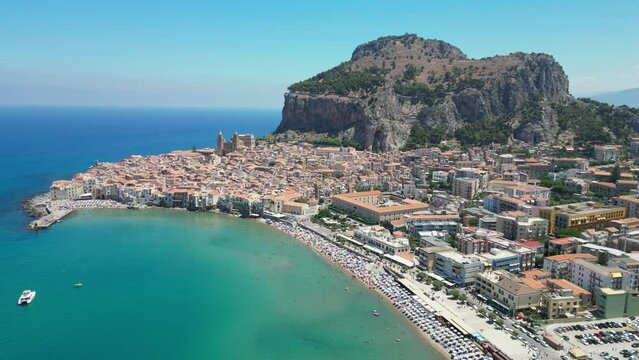 Cefalu City, Beach, Rock and Boulevard during Summer in Sicily, Italy - Aerial 4k