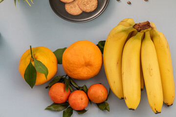 Bright orange tangerines and ripe bananas. Fruit plate