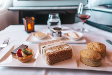 Business Class snacks served on a tablecloth during an airplane long haul flight.
