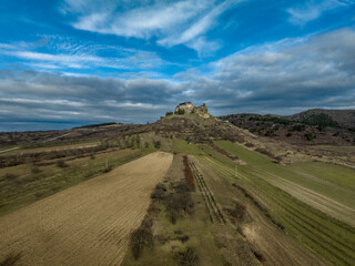 Aerial view of partially restored Boldogko, medieval Gothic castle in Borsod county Hungary with round gate tower, donjon cloudy blue sky background