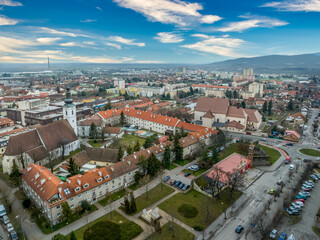 Fototapeta na wymiar Aerial view of Pezinok (Bazin) medieval castle with restored red roof and medieval wine trading town center with Gothic church and traces of city wall in Slovakia 