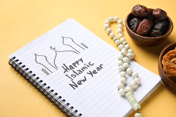 Notebook with text HAPPY ISLAMIC NEW YEAR, food and prayer beads on yellow background, closeup