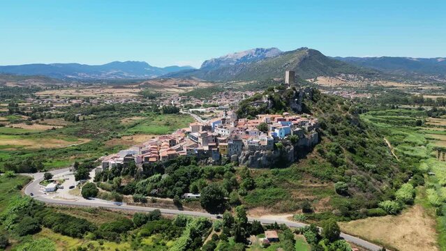 Posada Village and Tower on Top of a Hill at Sardinia, Italy - Aerial 4k