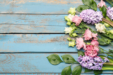 Composition with beautiful spring flowers on color wooden background © Pixel-Shot