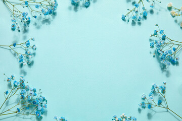 Frame made of gypsophila flowers on color background. Hello spring