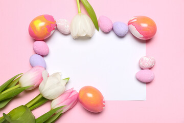 Composition with blank card, painted Easter eggs and tulip flowers on pink background
