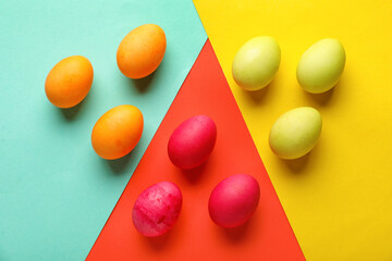 Composition with beautiful painted Easter eggs on color background
