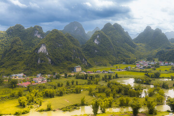The river going down the valley surrounded by limestone rock formations in Guangxi, China