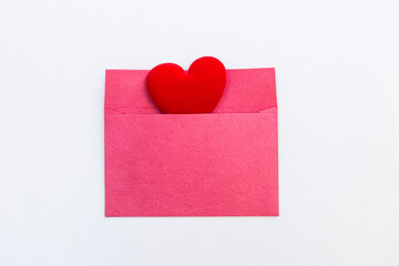 Red heart in pink paper envelope isolate on white background, love and romance concept, valentine's card background idea