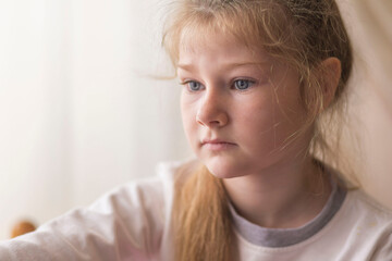 portrait of a beautiful emotional blonde girl in her room