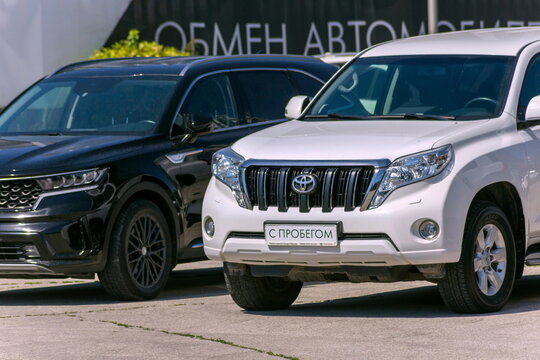 Russia Samara june 2022: used cars for sale in the store. Text in Russian: with mileage