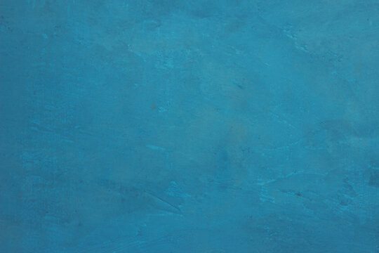 Blue light concrete texture for background in summer wallpaper. Cyan cement colour sand wall of tone vintage. Abstract teal dark color.
