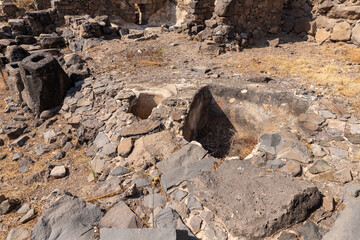 Containers  carved into the stones to collect the squeezed out oil on the ruins of the Gamla city, Golan Heights, northern Israel