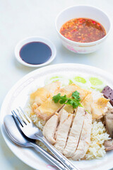 Hainanese chicken rice,Rice steamed chicken soup with cucumber and sauce